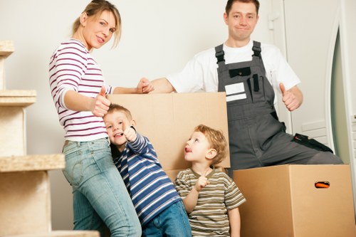 Professional team moving a piano through a narrow Cranford property